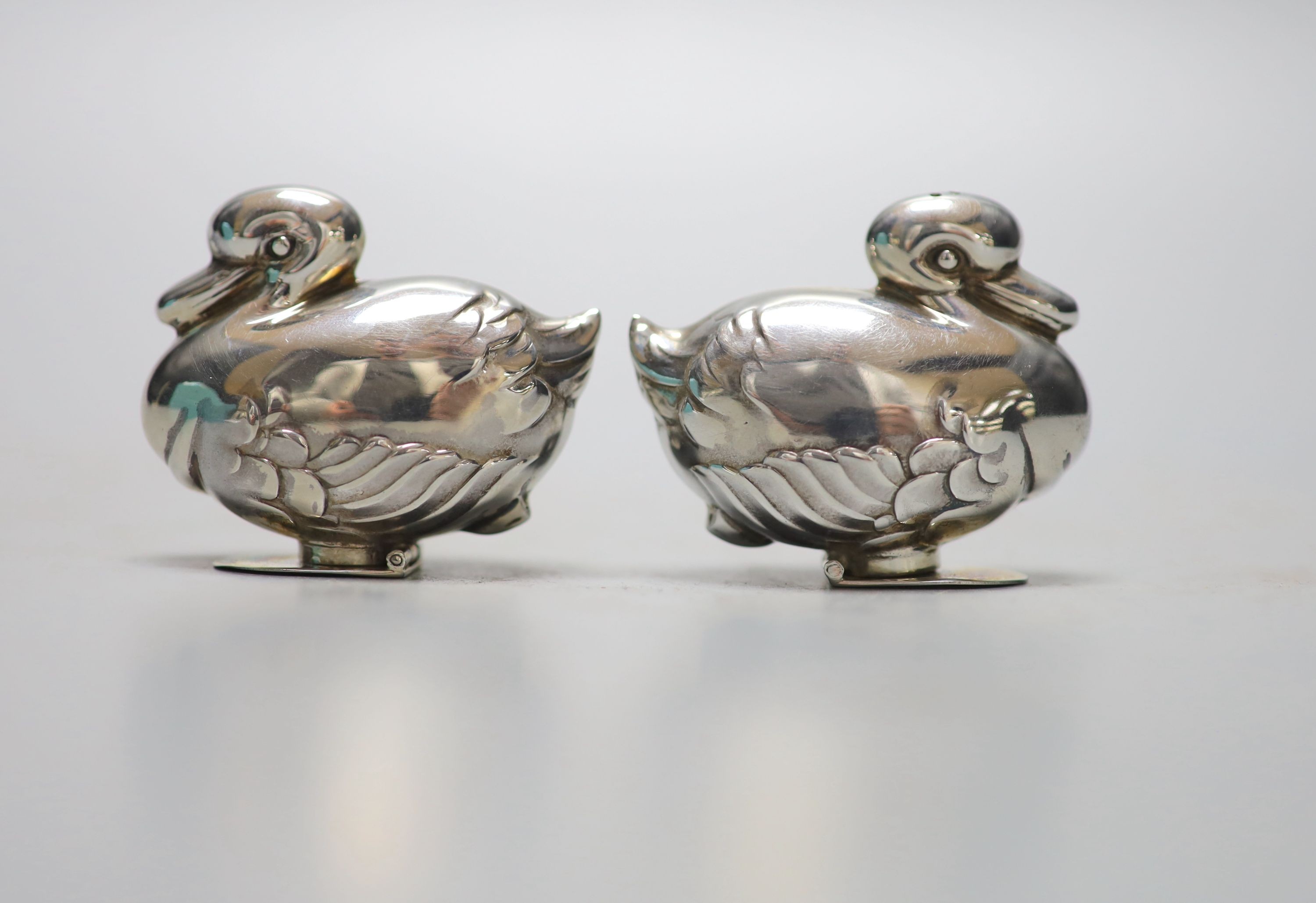 A modern pair of Tiffany & Co novelty silver condiments, modelled as a pair of ducks, height 4cm, with original box etc. import marks for London, 1990.